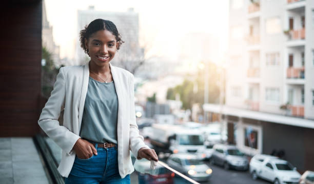 You can’t hide ambition…and why should you anyway? Portrait of a confident young businesswoman standing outside on the balcony of a modern office anyway stock pictures, royalty-free photos & images