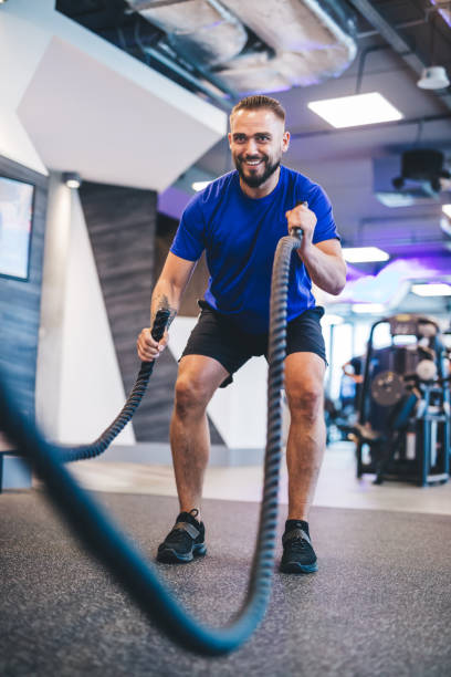 istock Man exercising with ropes at the gym. 1041513770