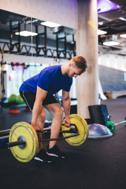 istock Muscular man lifting weights at the gym. 1041513842