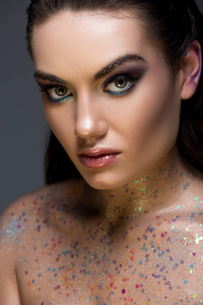 istock attractive glamorous model posing with glitter on body, isolated on grey 1041514750