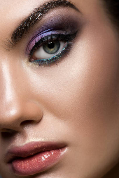 istock Close up of young model posing with glitter makeup looking at camera 1041514784