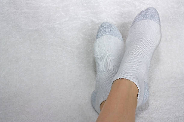 istock Feet Crossed Wearing White Socks 104152002