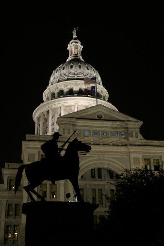 Texas Capitol with Ranger Statue at night