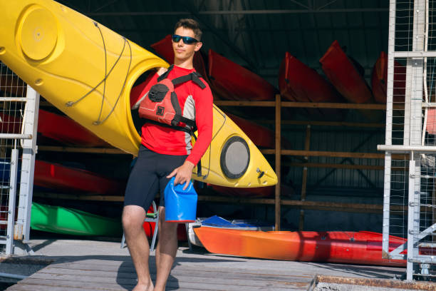 istock man carries a kayak 1041541514