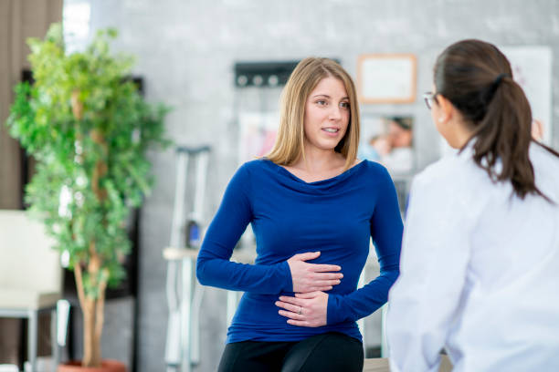 istock Woman Holding Her Stomach 1041548478