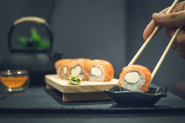 istock Philadelphia roll on wooden plate and fruit tea 1041557014