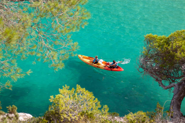 Menorca Kayak Menorca, Spain - august 16, 2018: father and son kayak experience scuba diving family stock pictures, royalty-free photos & images