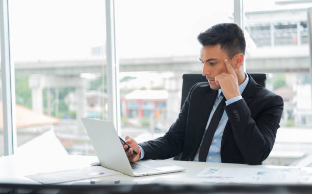 istock Concentration of businessman is thinking and using smartphone. 1041561918