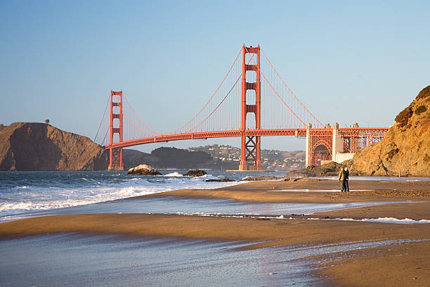 Couple with Golden Gate Bridge  baker beach stock pictures, royalty-free photos & images
