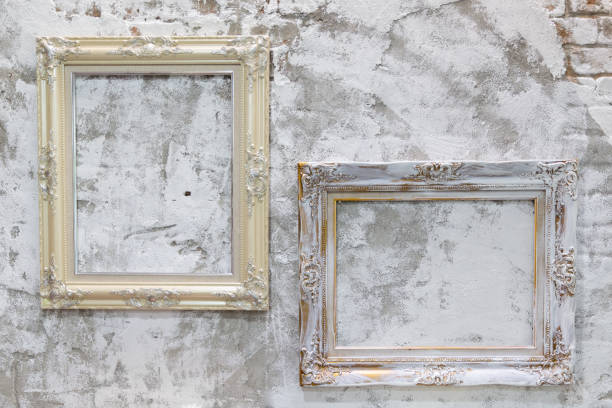 istock two empty vintage photo frame on old dirty concrete wall. 1041574548