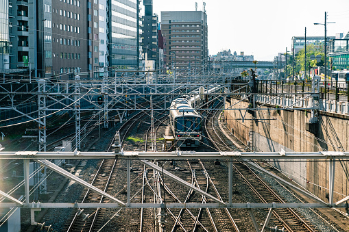 the view of japanese railway with related electronic structures by a background of tall buildings and street.