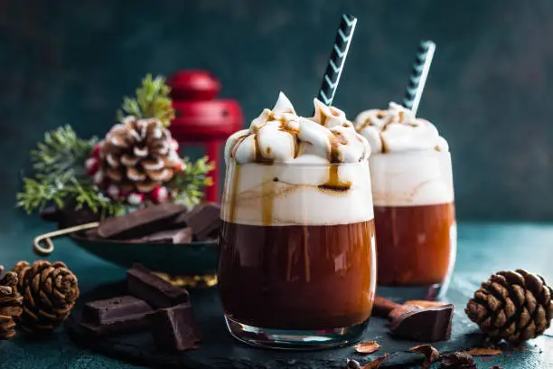 Photo of Hot chocolate with whipped cream. Chocolate drink and Christmas decorations
