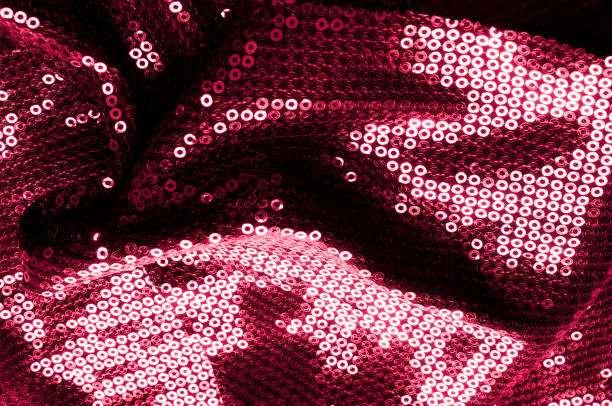 istock Background texture, pattern. Cloth red maroon with paillettes. Look at these Neon Pink Paillette Sequins. Round neon pink paillette sequins overlap with an iridescent sheen across a sheer purple mesh 1041585658