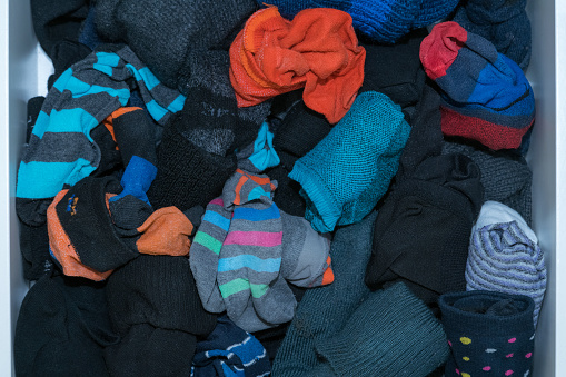Used sock in wood tray ,man and women socks in an open drawer, warm winter