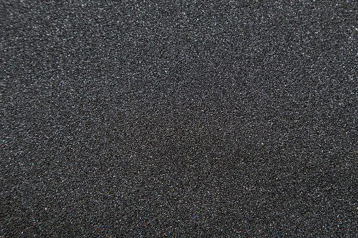 Close up of of skateboard grip tape. Macro photograph of sandpaper texture