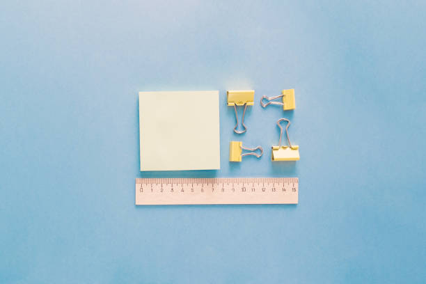 istock School supplies placed in pattern on a blue background. Back to school and education concept. Office supplies as ruler, paper clips and memo pads. 1041607372