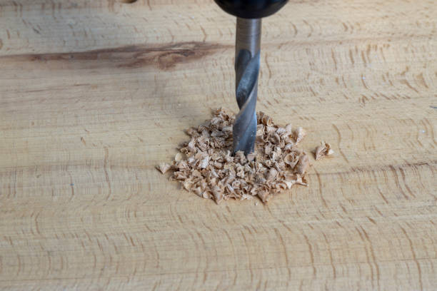 istock metal drill bit make holes in a wooden plank 1041607822