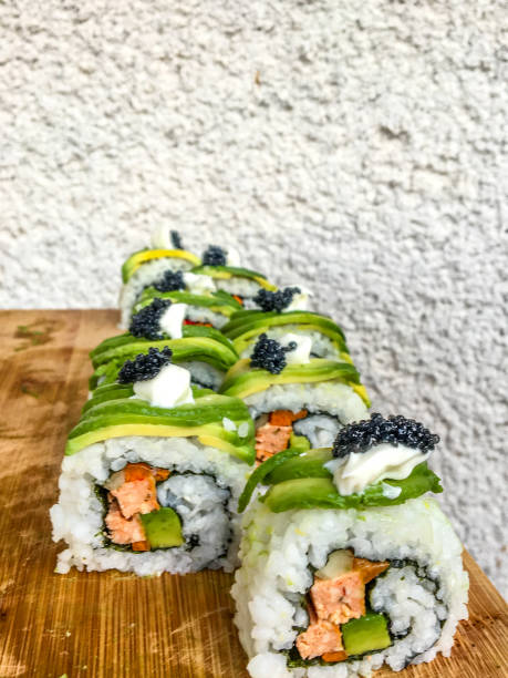Vegan california Sushi roll made of Tofu, Avocado, Cucumber, Carrots, Vegan Mayonnaise and fake Caviar