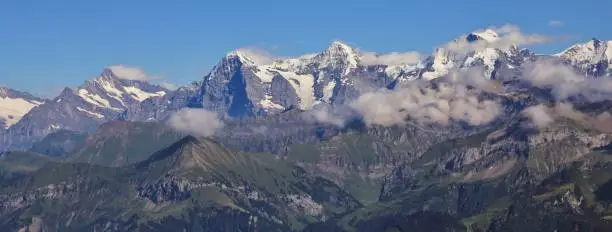 Famous mountains Eiger, Monch and Jungfrau seen from Mount Niesen, Switzerland.