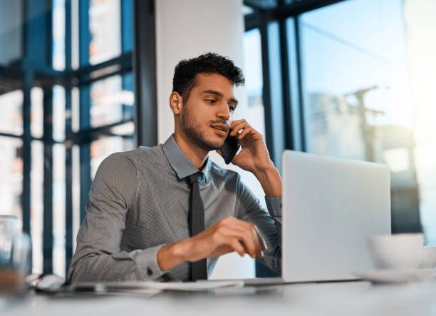 istock Calling up a few of his clients 1041618618