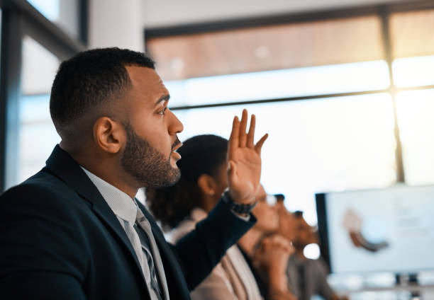 I'd like to add to that Shot of a young businessman raising his hand during a meeting in an office people in a row photos stock pictures, royalty-free photos & images