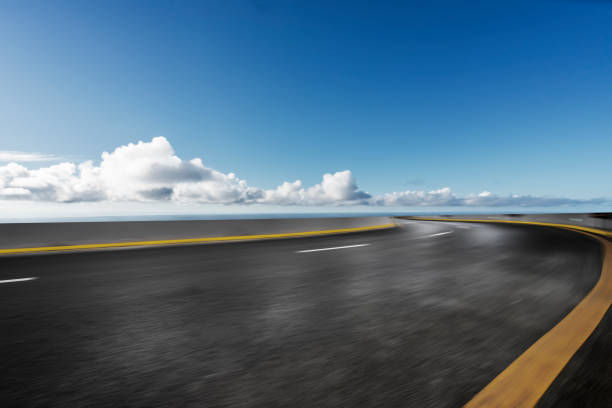 istock road by sea against blue sky 1041620416