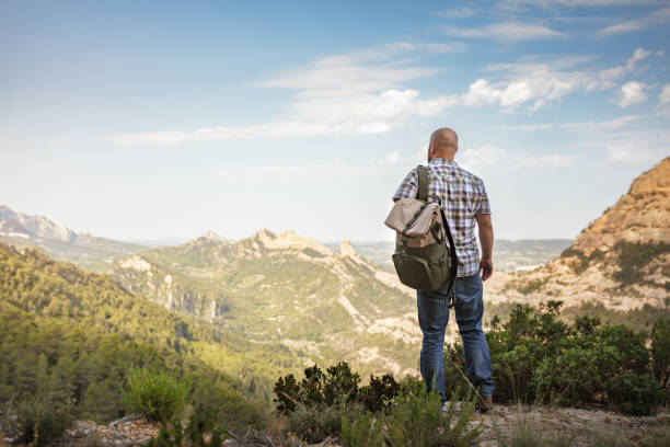 Vintage image of traveler with backpack in mountains