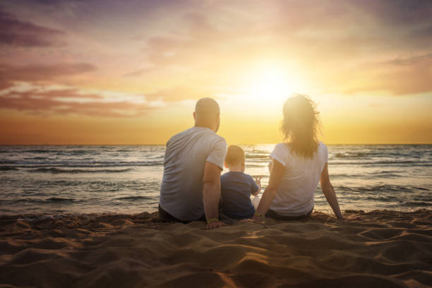 istock Family at the beach on sunset 1041626218