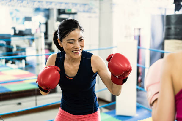 istock Two women training at boxing gym 1041630800