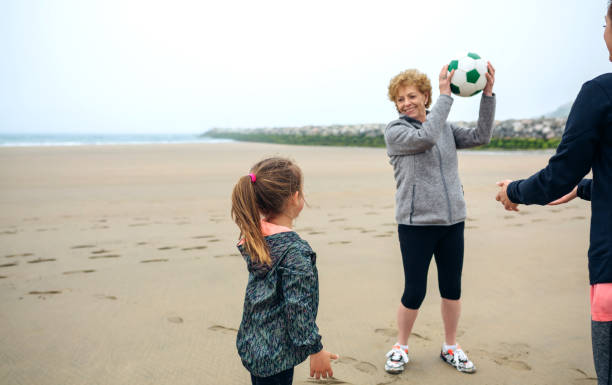 istock Three generations female playing on the beach 1041634142