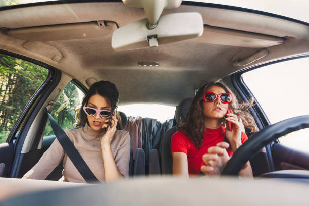istock Two serious young business lady in car 1041634768