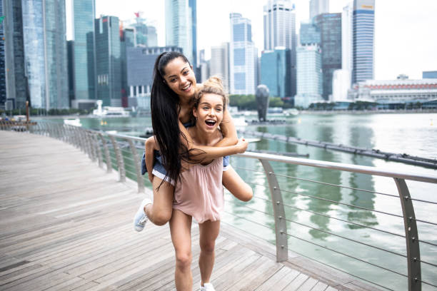istock Girls having fun in piggyback ride 1041637444
