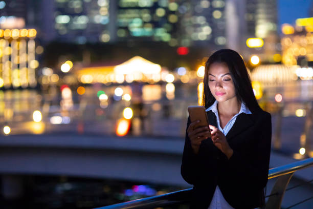 istock Woman typing outdoors at night 1041637470