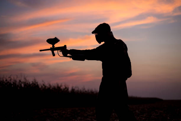 istock Silhouette of a paintball player 1041640288