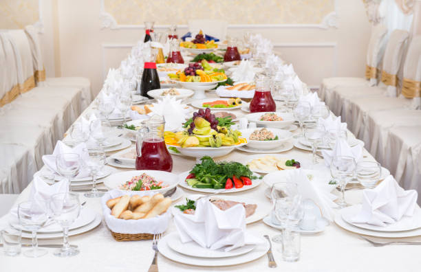 istock Served holiday table, cutlery, crockery, snacks, glasses, white tablecloth, chairs 1041641082