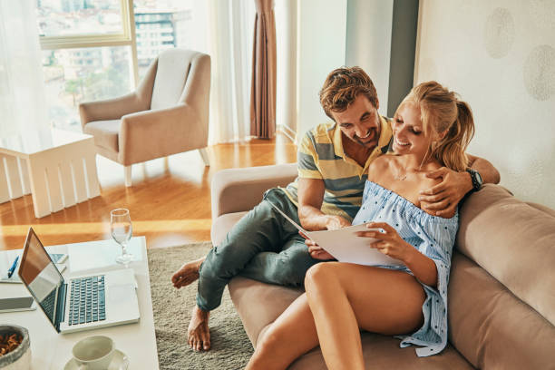 istock young couple sitting and relaxing together reading 1041647704