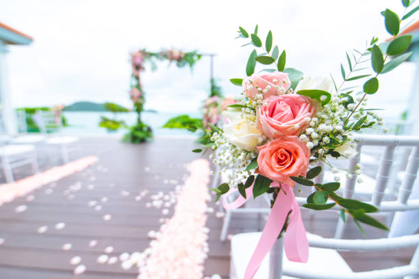 istock 08/28/2018Chair decorated with flowers in Wedding ceremony. 1041652588