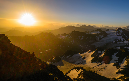 A beautiful summer sunrise over the Swiss alps, many of the famous peaks are visible from the summit of Mont Fort near Verbier: Dent Blanche, Matterhorn, Weisshorn and Dent d'Herens.