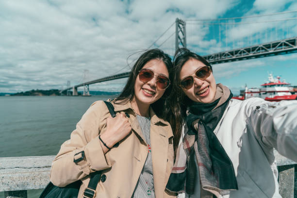 istock sisters taking selfies with a sightseeing view 1041657846