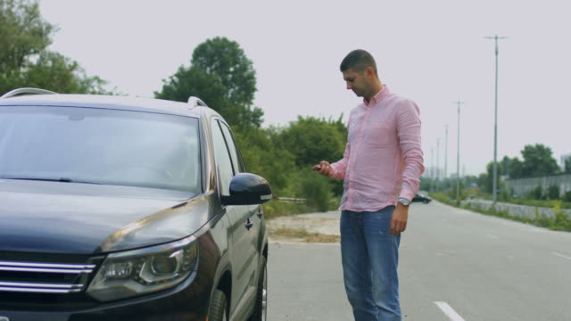 Man unlocking car's door with remote control car