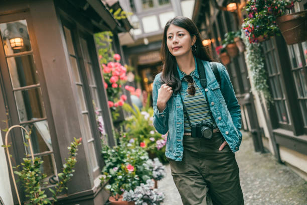 istock girl walking in alley surrounded by building 1041663306