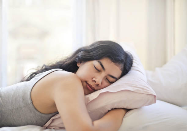 istock Young woman sleeping in her bed 1041674344
