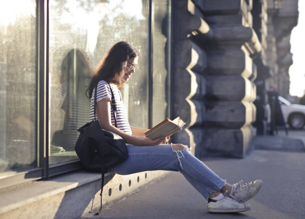 istock Girl sitting with the book 1041676204
