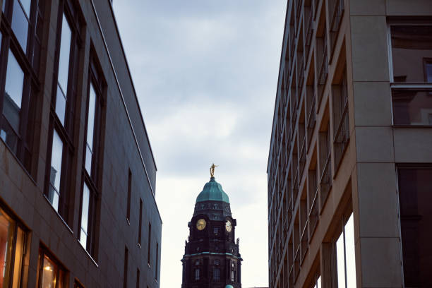 istock low angle view of tower with clock between modern buildings in Dresden, Germany 1041676460