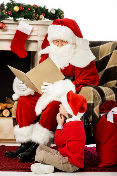 istock santa reading book to little kid while he sitting on carpet 1041690662