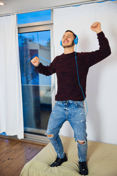 istock Young Man Having A Solo Party At Home 1041692318