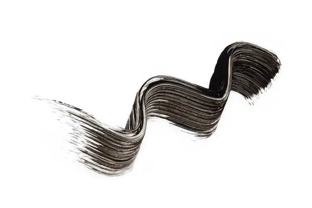 Photo of black mascara design wave drawing on white background