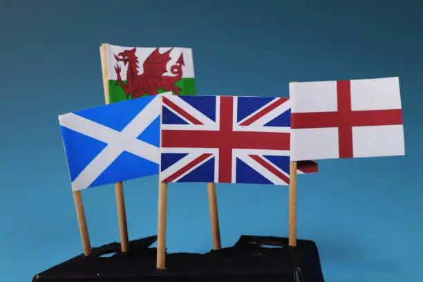 Photo of A United kingdom flag and their members as Scotland, England, Nothern Ireland, Wales