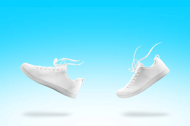 istock Pair of White sneaker composition like walking and floating rope isolated on blue and white gradian background with clipping path 1041705596