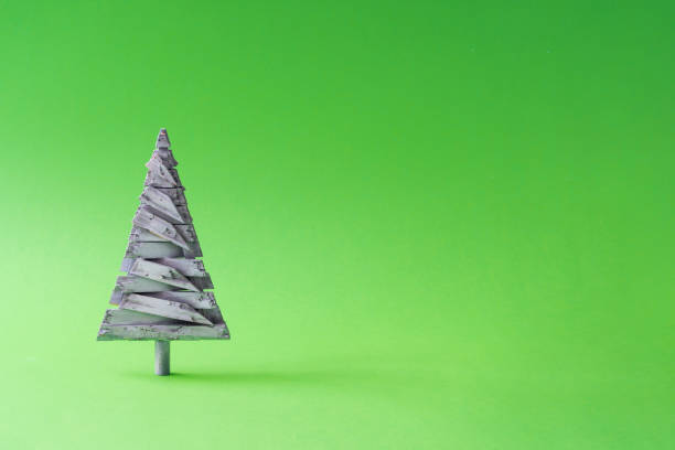 istock White wooden Christmas tree decoration with green background. 1041709720